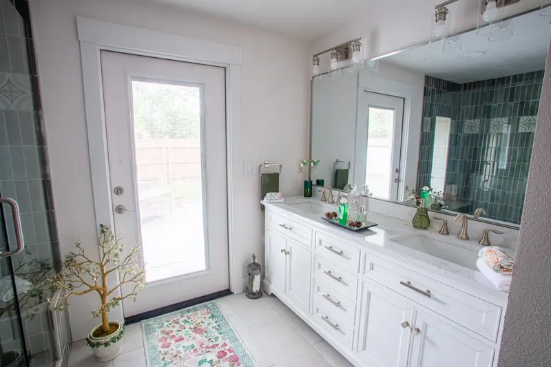 Walk-in shower with vertical blue-green tile and patterned accent band, Boise bathroom remodel by R2F Construction